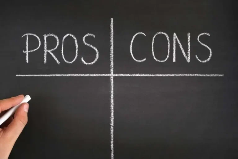 A hand holding chalk is about to write on a blackboard labeled "PROS" and "CONS," divided into two sections.